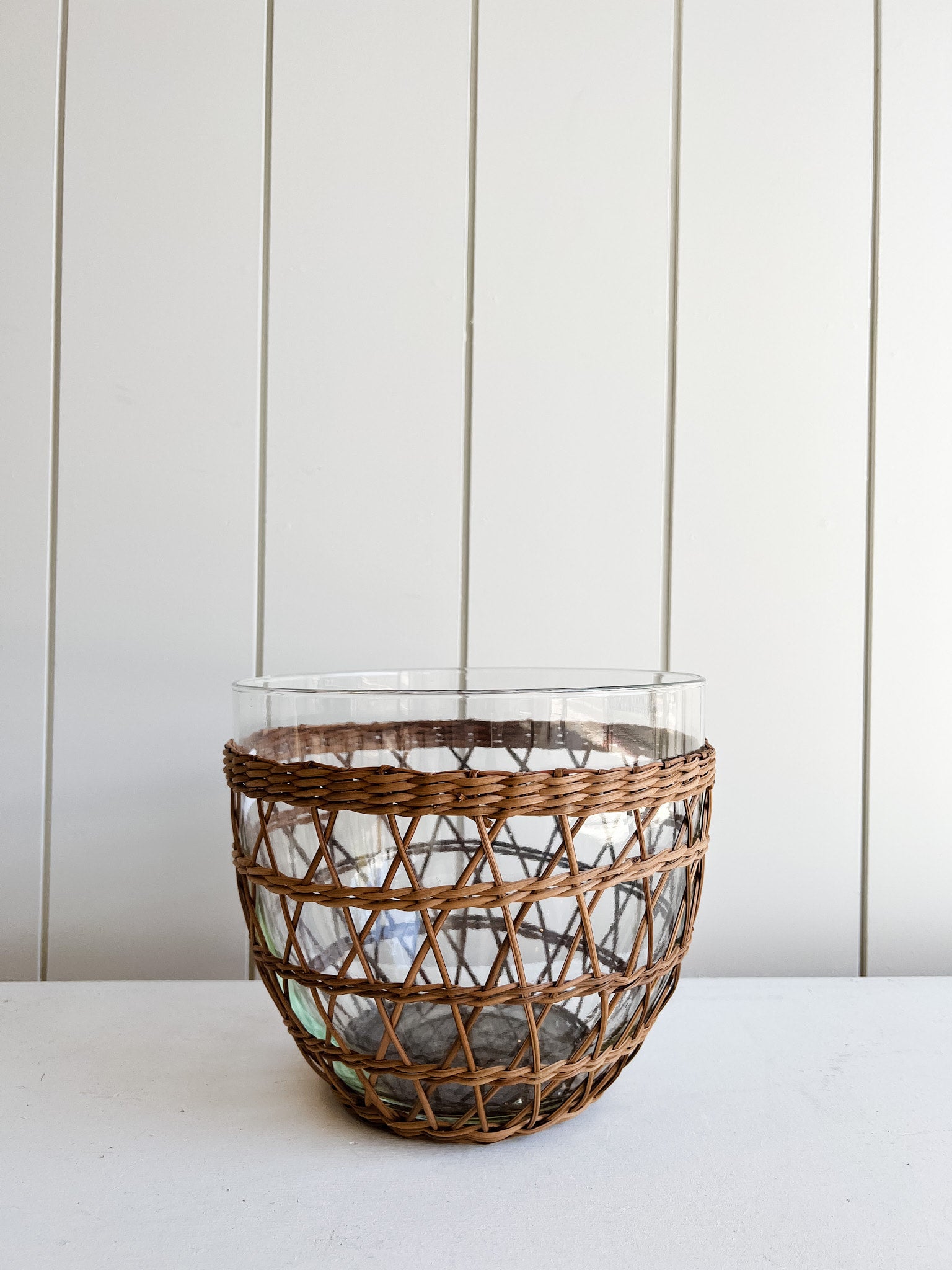 Glass salad bowl with woven rattan holder